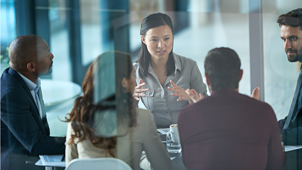 Personen diskutieren über etwas in einem Sitzungsszimmer
