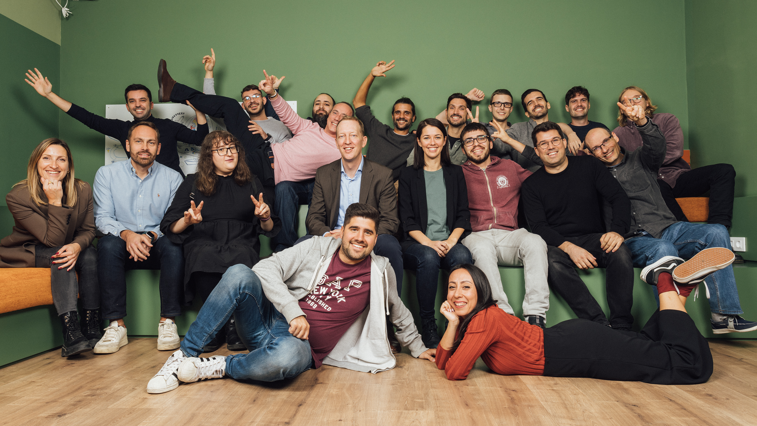 Team picture in front of a green background