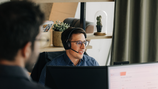 Cloud Engineer Man sitting in front of a computer with headset