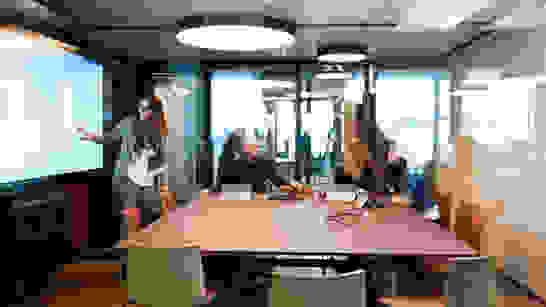 isolutions Academy Trainee Besprechung in einem Sitzungszimmer mit vier Personen