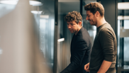 Offene Stelle bei isolutions als Lead M365 Cloud Engineer Operations Männlicher Lead M365 Cloud Engineer Operations steht mit Mann vor Surfacehub