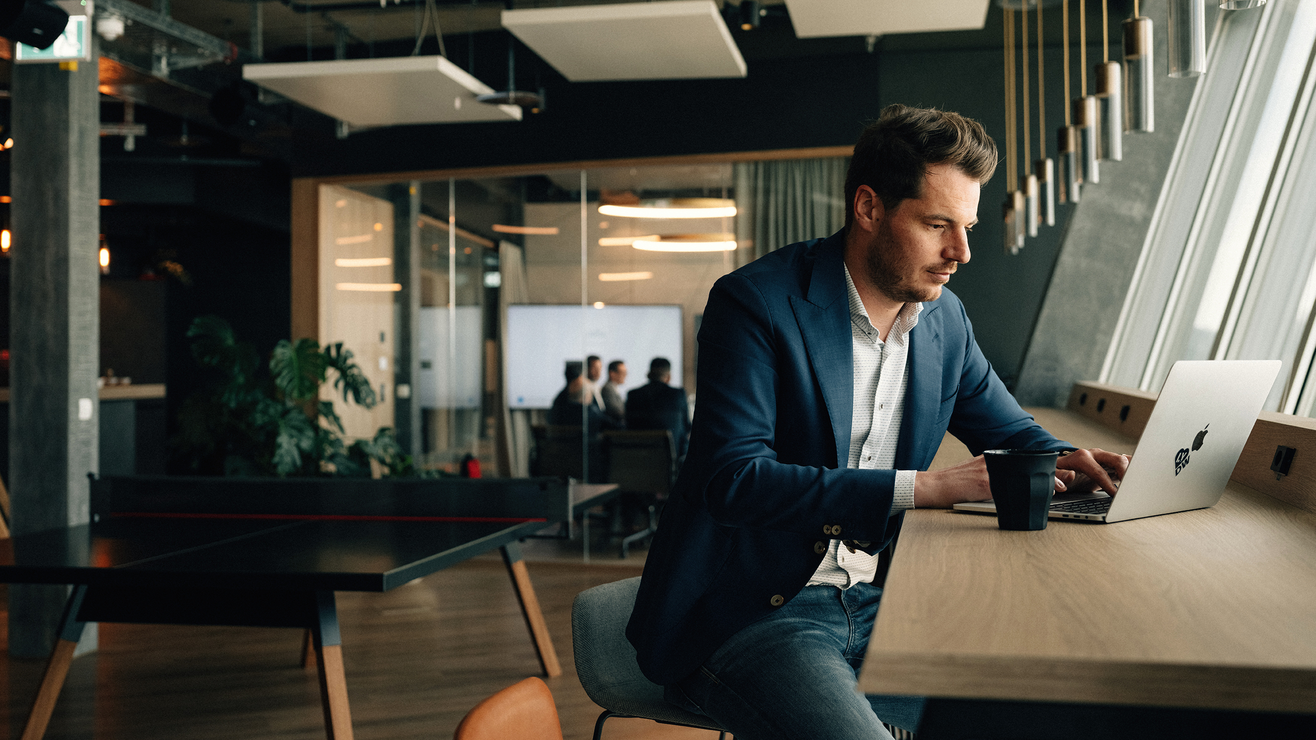 Man sitting on a desk with a computer